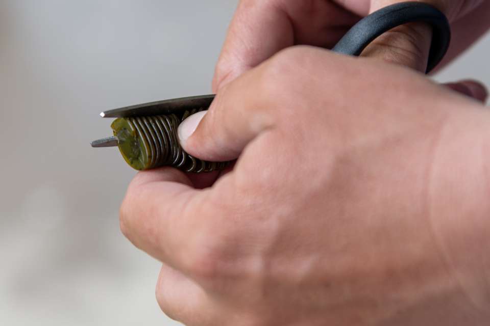 He then cuts off the sides of the D Bomb to reduce the width of the lure.
