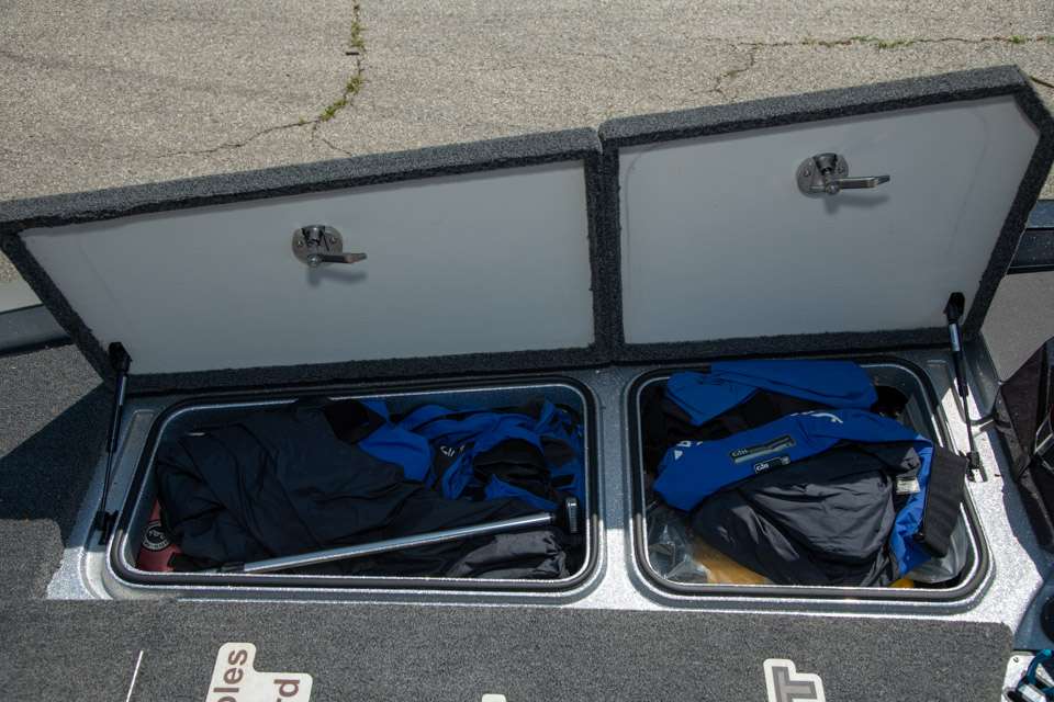 Two cavernous compartments on the right side of the deck are used to store life jackets, rain gear, his running light and tons of other gear.