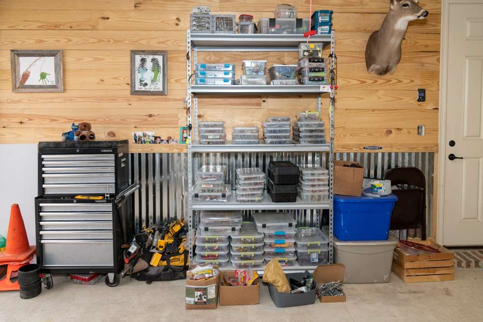 Shelving holds all of his tackle in carefully organized boxes.
