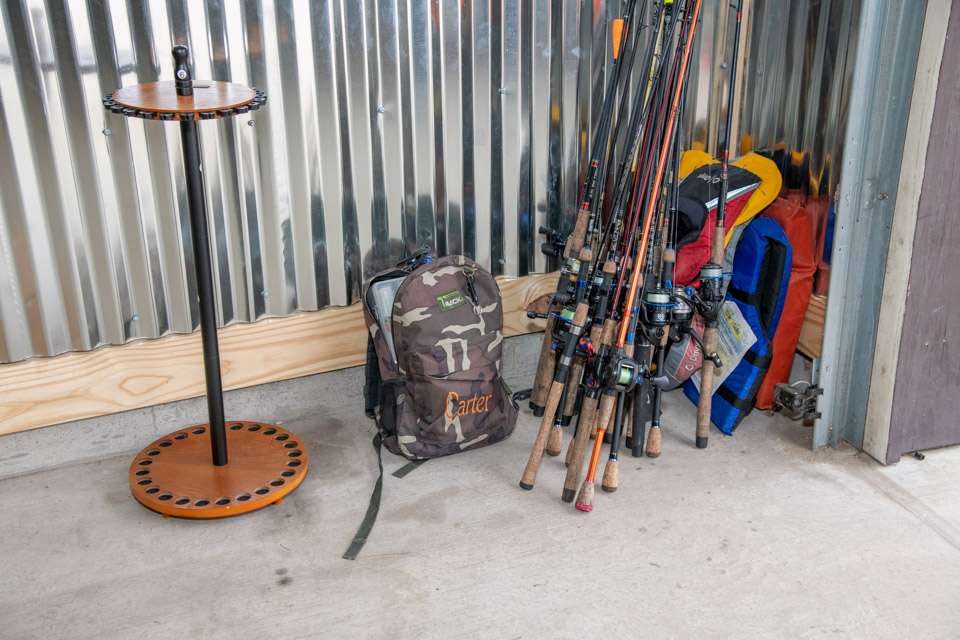 Extra rods and reels, along with other fishing paraphernalia, are leaned in corners.