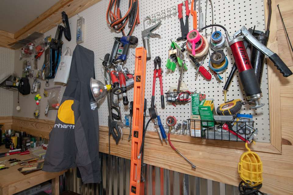 Assorted tools and accessories are hung on pegboards to keep them handy.
