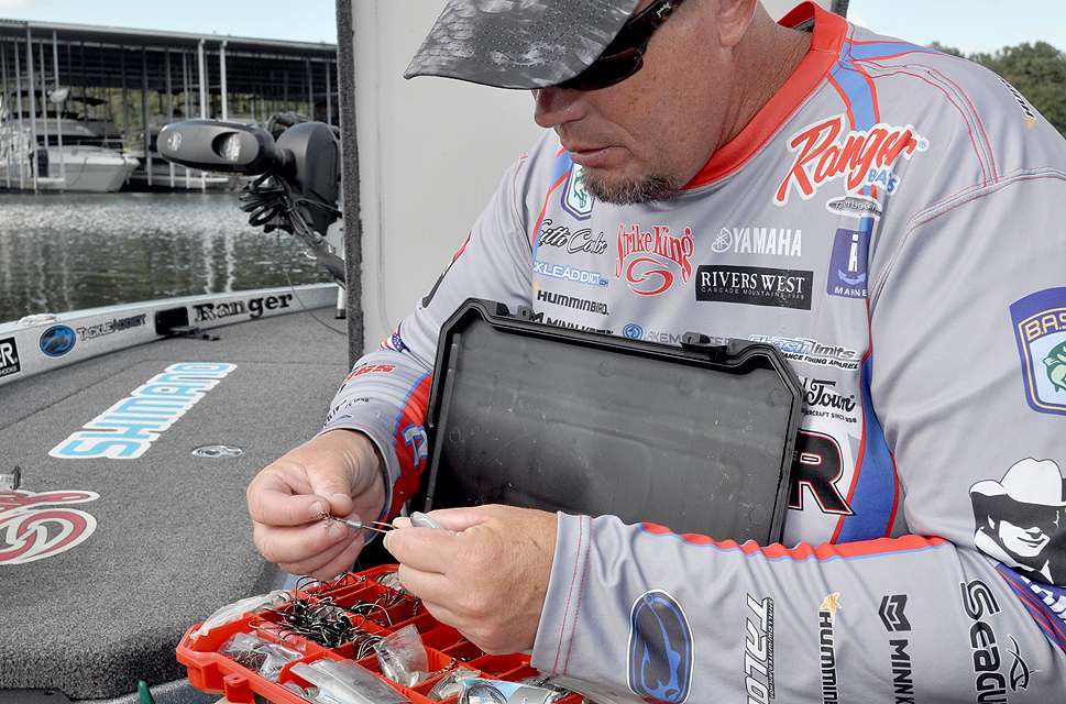Combs retrieves a 5/0 Owner Weighted Twistlock CPS Hook from his hook box. It features a spring screw keeper and a 1/8-ounce weight on its shank.