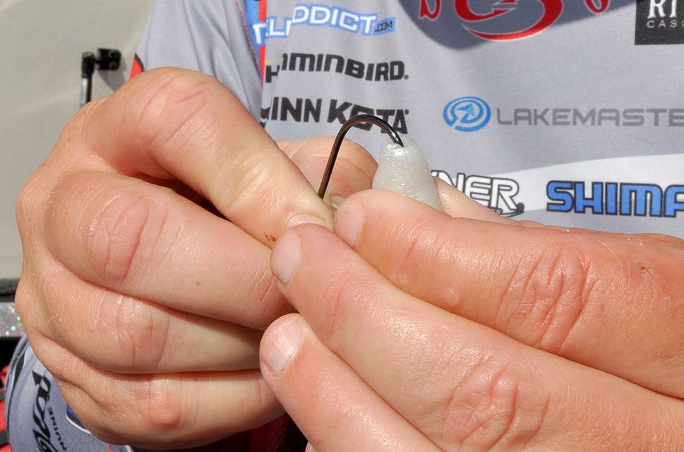 Combs threads the hook into the head of a pearl 5-inch Strike King Caffeine Shad.