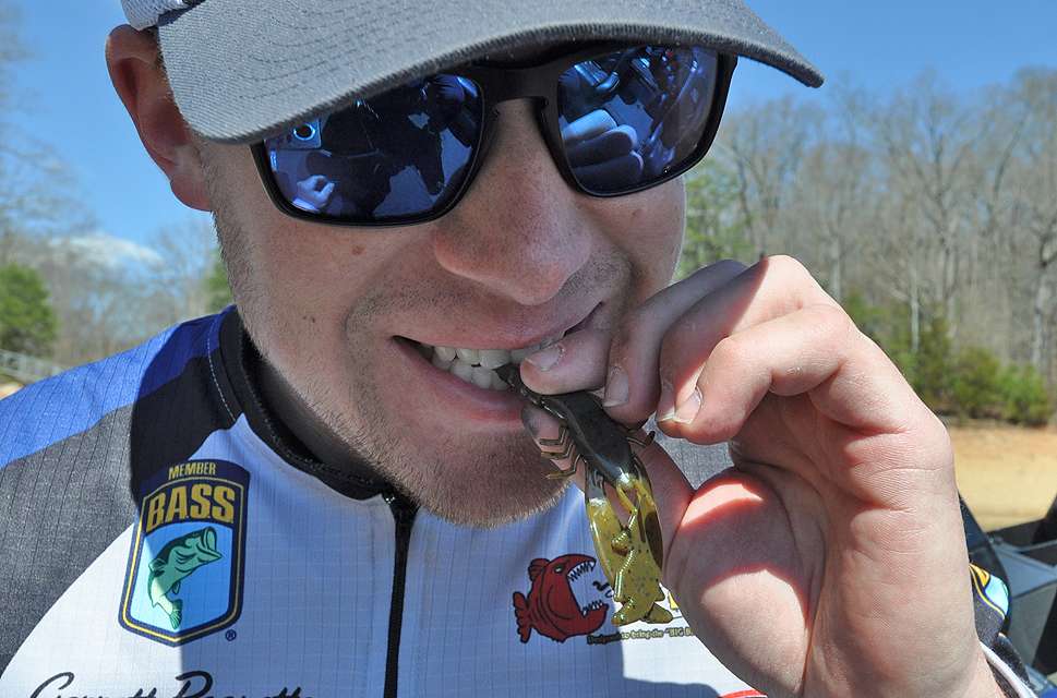 Paquette bites off a few sections of the College Crawâs tail to shorten the bait.