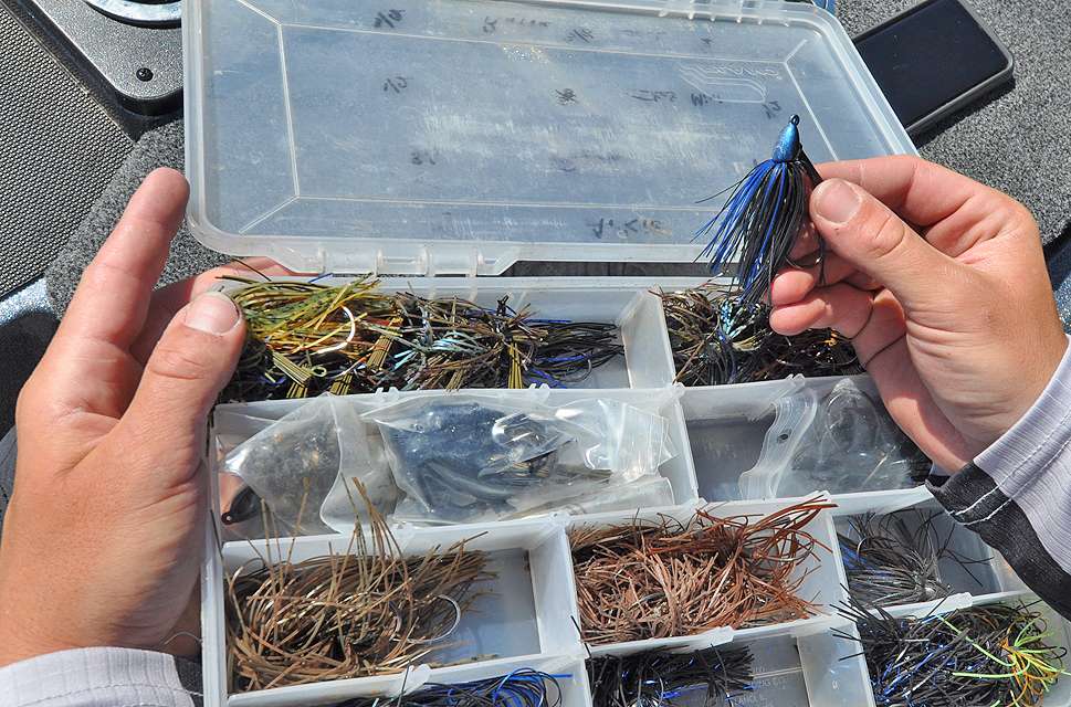 Paquette selects a 3/8-ounce, black/blue Molix Tenax Jig from one of his Plano jig boxes.