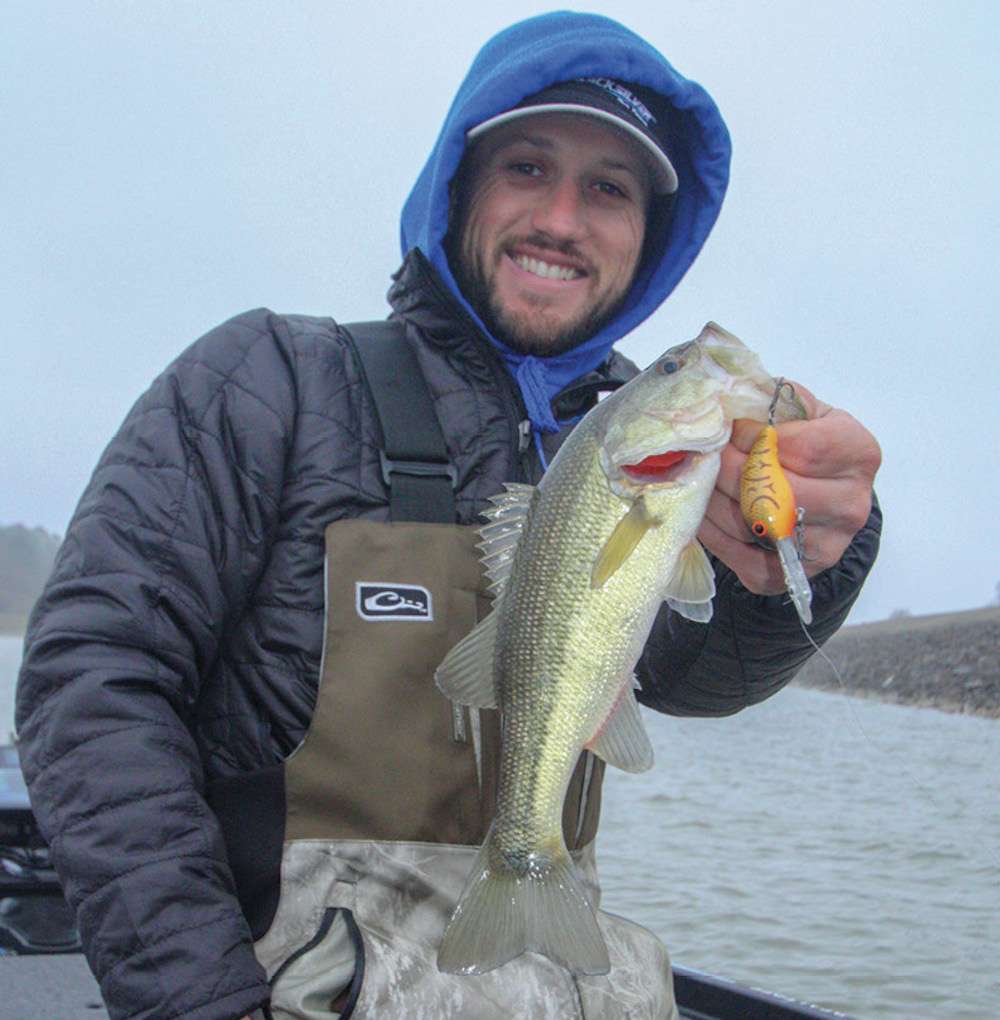 <b>8:04 a.m.</b> Blaylock bags his first keeper largemouth of the day off the riprap; it weighs 1 pound, 2 ounces. âThat fish was pretty shallow. I only cranked the Bandit a couple of turns when he hit it.â
<p>
<b>6 HOURS LEFT</B><BR>
<b>8:10 a.m.</b> Blaylock tries a shad-pattern Smithwick Elite 8 jerkbait on the dam. âThese arenât ideal conditions for a jerkbait, but Iâm seeing so much stuff suspended, I need to try it awhile. Iâve caught plenty of fish in surprisingly muddy water on jerkbaits; you just need to adjust your color and retrieve for low-visibility conditions.â To prove his point, he catches a nonkeeper on his first cast with the minnow mimic. <br>
<b>8:17 a.m.</b> Still jerkbaiting the dam. The wind has picked up out of the north; it feels like 20 degrees. âThat cold front wasnât due here until late afternoon, but itâs already blowing in. Iâd love to get on some good fish quickly because conditions are only going to get tougher.â <br>
<b>8:22 a.m.</b> Blaylock tries a 1/2-ounce red craw Booyah One Knocker lipless crankbait on the dam. <br>
<b>8:26 a.m.</b> Upon reaching the end of the dam, Blaylock casts the jerkbait and the One Knocker. <br>
<b>8:31 a.m.</b> Blaylock runs to a nearby cove and pitches a homemade 1/2-ounce black and blue jig with a matching Yum trailer to a dock. âThere may not be any bass in here, but it sure feels good to get out of that cold wind!â <br>
<b>8:35 a.m.</b> Blaylock has spotted a submerged brushpile with a wad of fish around it on his graph, and tries the jerkbait. No takers. <br>
<b>8:40 a.m.</b> Blaylock drags a pink Yum finesse worm on a drop-shot rig around the brushpile. A fish nips the lure; Blaylock sets the hook and swings a tiny bass aboard. âThatâs probably the size fish Iâm seeing around that brushpile on my electronics.â <br>
<b>8:47 a.m.</b> Blaylock moves off the brushpile and begins circling the cove with the spinnerbait and homemade jig. âIt gets shallow back here in a hurry. Iâll have better luck closer to deep water.â <br>
<b>8:54 a.m.</b> He hits several docks near the coveâs mouth with the shaky head worm, jerkbait and drop shot.
<p>
<b>5 HOURS LEFT</B><BR>
<b>9:10 a.m.</b> Blaylock is back on the main lake, where heâs spent several minutes rummaging through his tackle stash. âBetter zip up your rain jacket because weâre running uplake. Hopefully, itâs not a lot muddier up there.â <br>
<b>9:21 a.m.</b> After a bone-chilling run, Blaylock arrives at a secondary point in the middle of a cove, where he casts the One Knocker. âThe channel runs in close to here, and itâs not overly muddy.â
