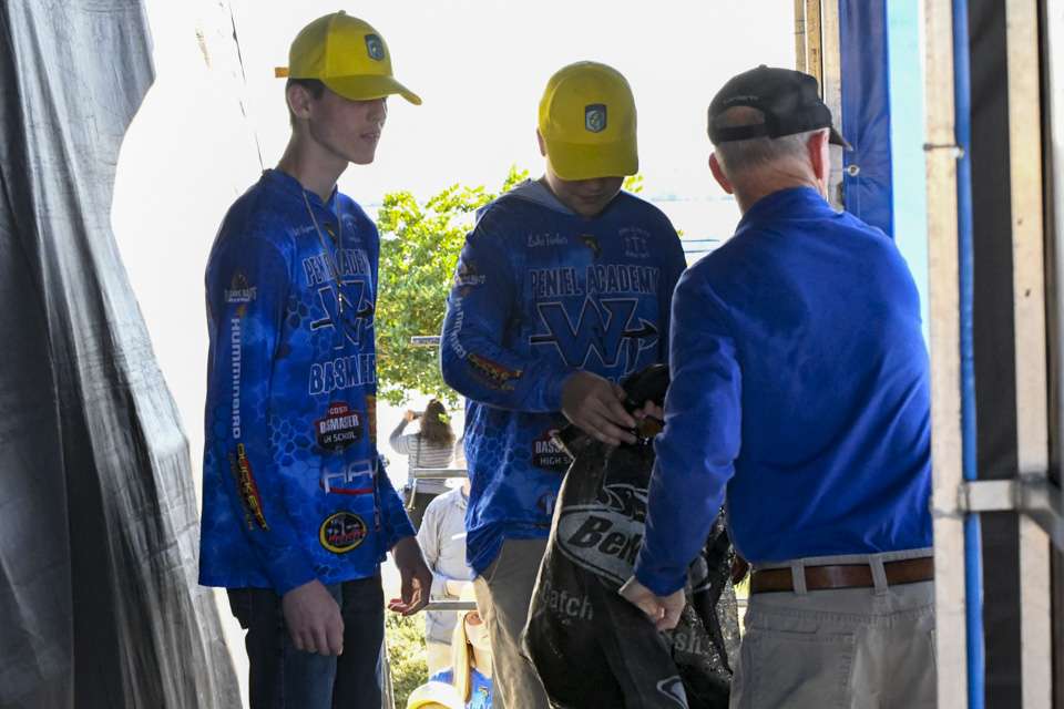 Luke Tincher and Wyatt Chapman were ready to take the bags from Bassmaster Tournament Director Trip Weldon and hand them to high school anglers off stage.
