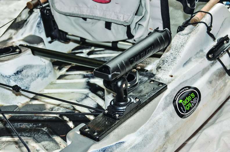 On the gunnel behind the seat, install rod holders that can adjust to horizontal. I used YakGear Railblaza holders, one a tube style, hard mounted. The other slid in a track with a MiniPort Tracmount. This makes the holder a bit higher and perfect for a spinning reel.
