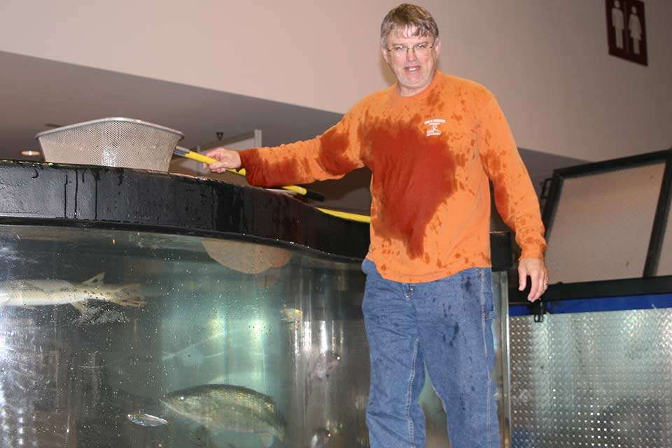 Kurt Lakin, a fisheries biologist for the TVA working on his booth, felt the wrath of a tail slap as he transferred fish into a display tank. He said getting soaked is just a hazard of the job.