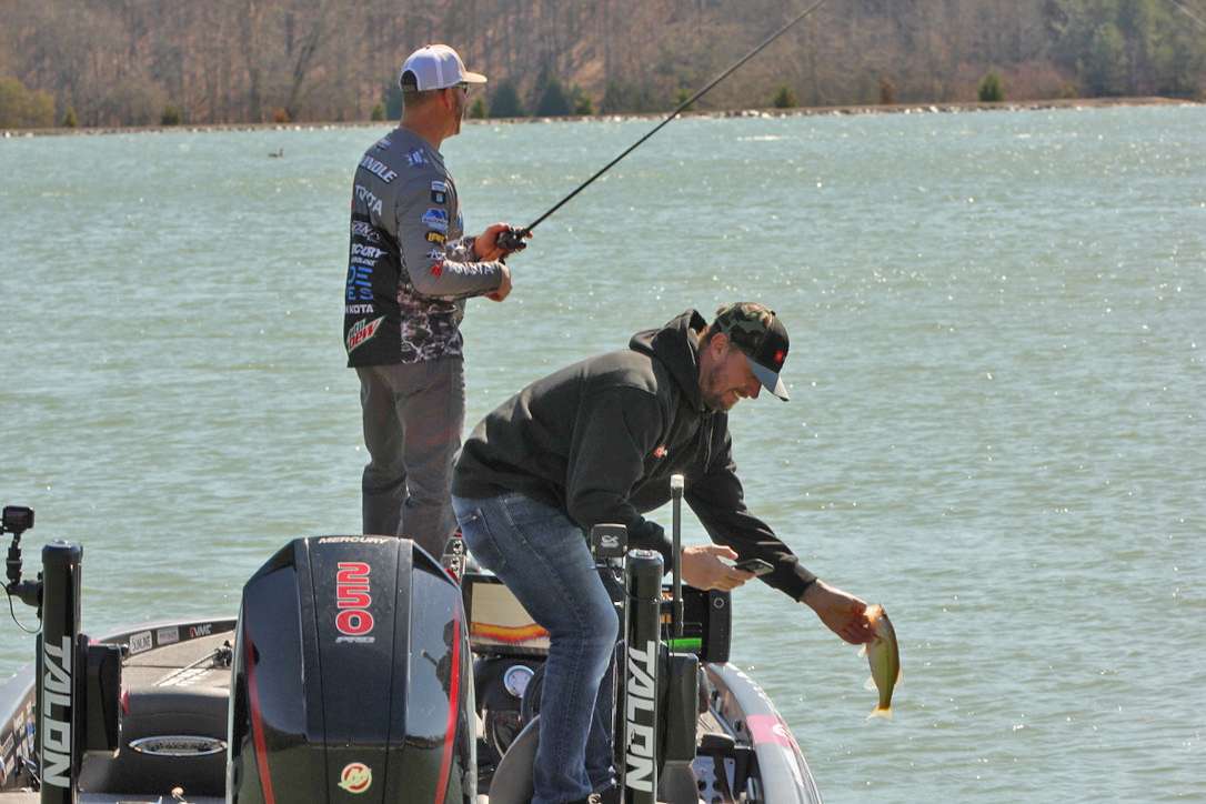 Meyer is on the board first, and while his catch is a bit undersized, he found the little largemouth worthy of a picture on his cell phone. 