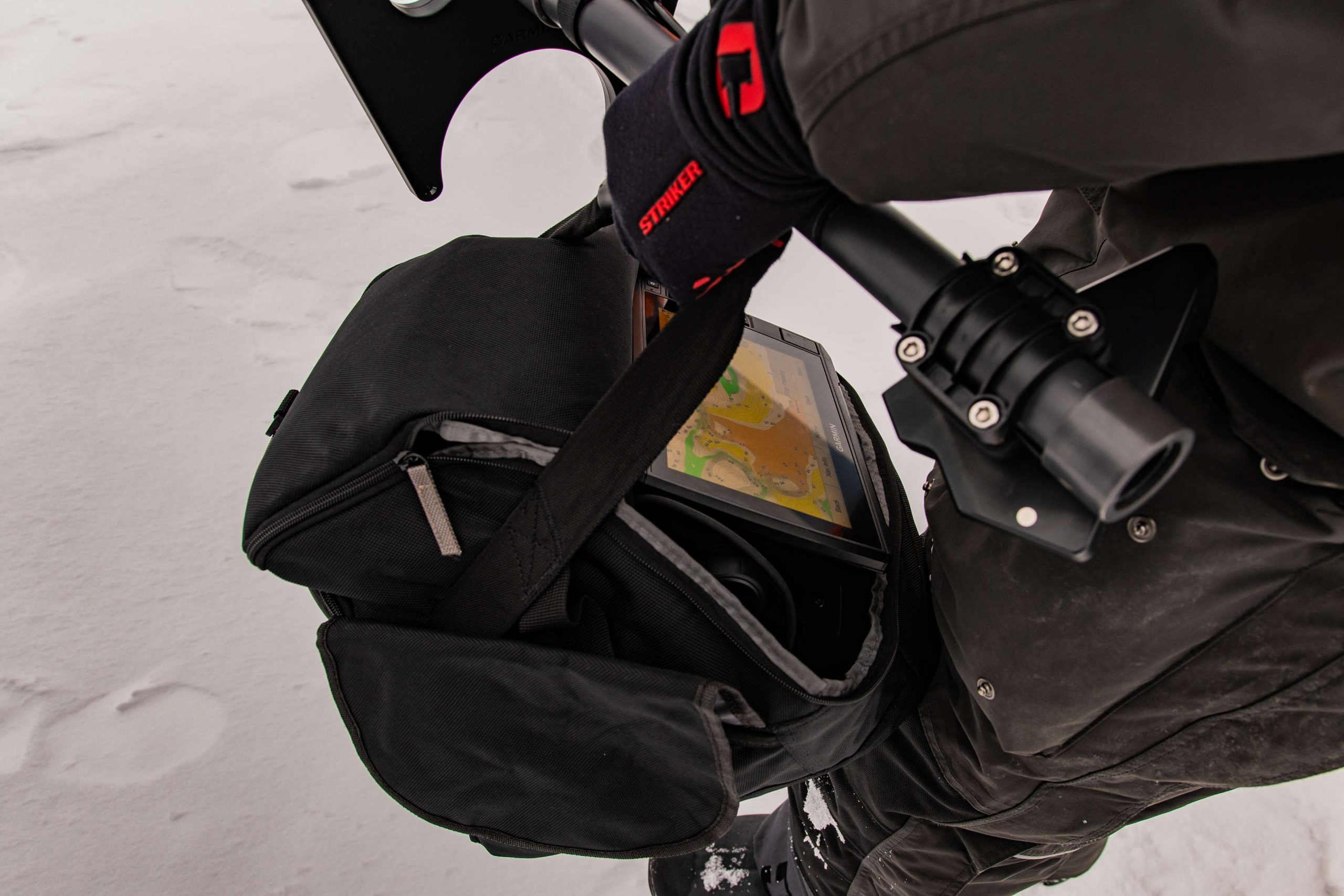 Mueller pulls all his gear in an Otter Ice Sled with a Hyfax Runner Kit, but when he gets to an area he likes, he grabs everything he needs to move around and look for fish all while staring at his Garmin map.