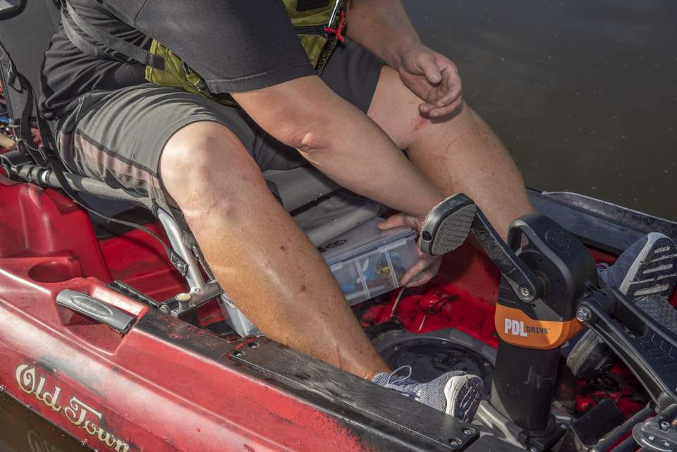 Keith Combs stores his tacklebox below the seat of his kayak so he can quickly switch lures.
