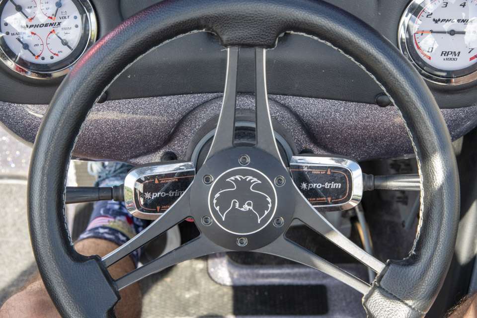 The steering column is flanked by two Pro-trim switches to control his jack plate and outboard tilt motor. âI never have to take my hands off the wheel,â he said. âI can control everything right there and keep both hands on the steering wheel.â