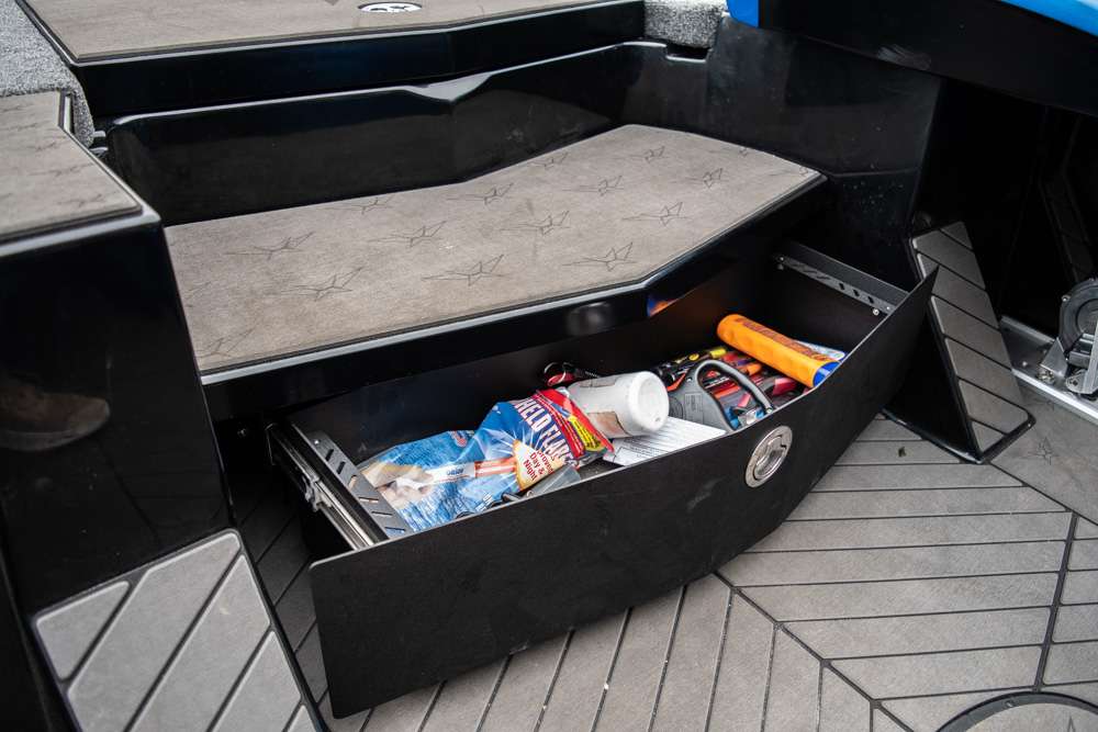 A pull out compartment next to the console of the boat is used by Huff to store items and tools that may be needed while fishing. Huff keeps items such as pliers, sunscreen and flares in this compartment. 