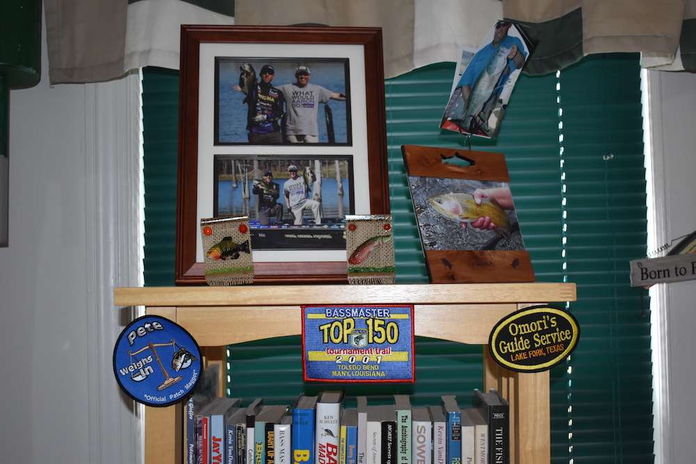 Even the bookshelf is loaded up with all sorts of fishing pictures and patches.