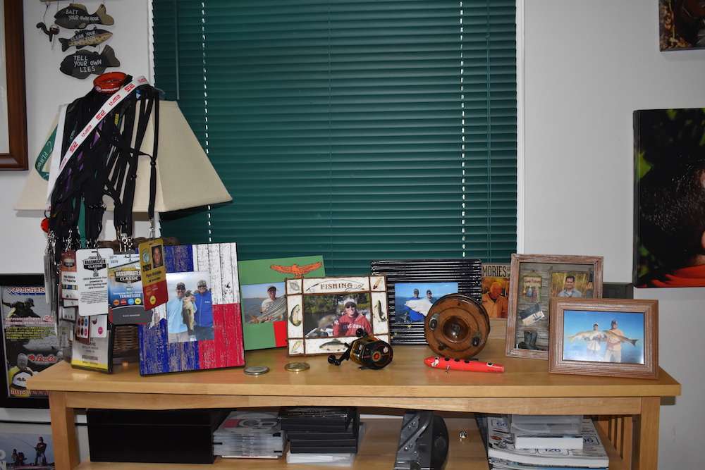 The small table along the front wall of the office has more fish pictures and other paraphernalia. 