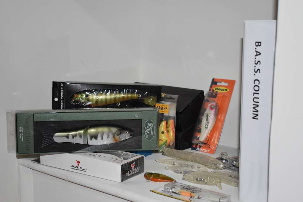 On the bottom of the built-in shelves there are a bunch of lures, including some expensive swimbaits, and various items autographed by top pros and lure designers.