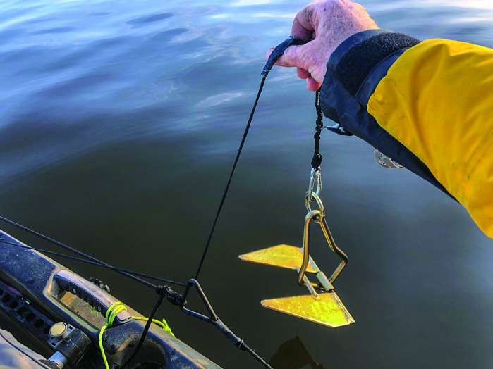 Drop anchor well away and (ideally) upwind from your target. Run your anchor trolley to the kayakâs stern and pay out enough anchor line for solid purchase in the lake floor. Claw anchors or fluke anchors (such as this Chene anchor) dig in well. Mushroom-style anchors or chains can drag.
