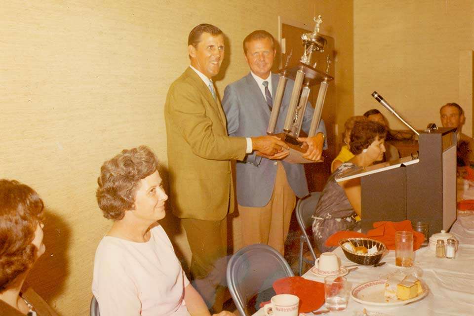 Blake Honeycutt was handed the trophy by B.A.S.S. founder Ray Scott at the 1969 awards banquet. Although it was with 15-fish daily limits, Honeycutt totaled 138 pounds, 6 ounces over three days, a mark never eclipsed in more than 700 subsequent tournaments.