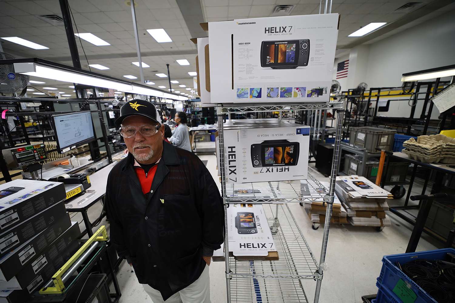 Herren stands by a stack of new Helix 7 units ready to ship out. 