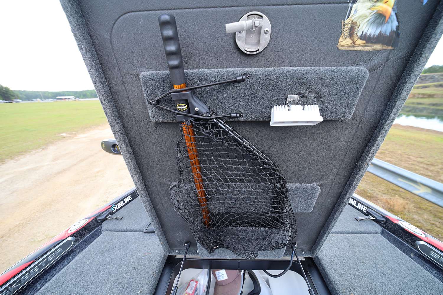 Inside the lid are lights and other items he needs access to. The net comes out of the boat during Elite events. 