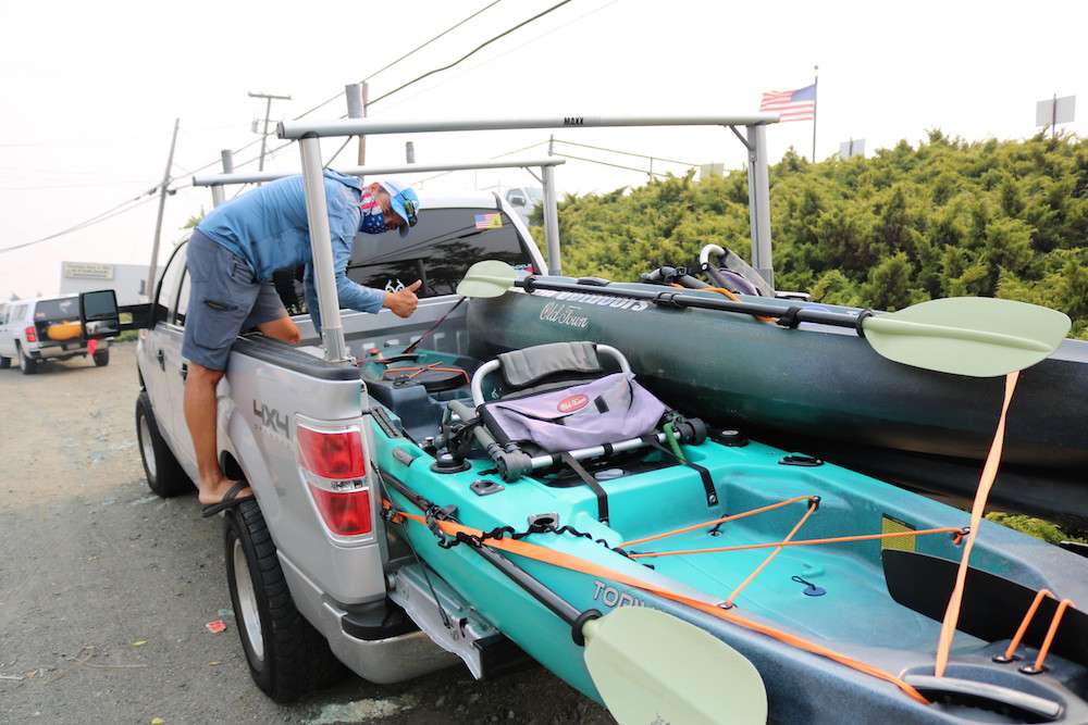 Gilbert Garcia secures his and his sonâs Old Town kayaks.