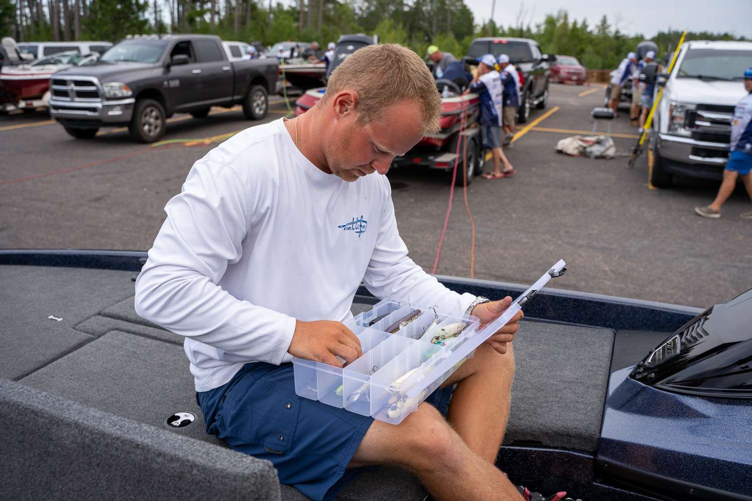Nearby, anglers get ready for Day 1. Eddie Levin from Ohio checks his trays.
