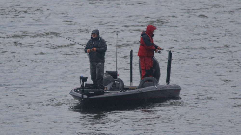 See the anglers fish during a downpour below the dam at Lay Lake during the Basspro.com Bassmaster Eastern Open in Alabama.