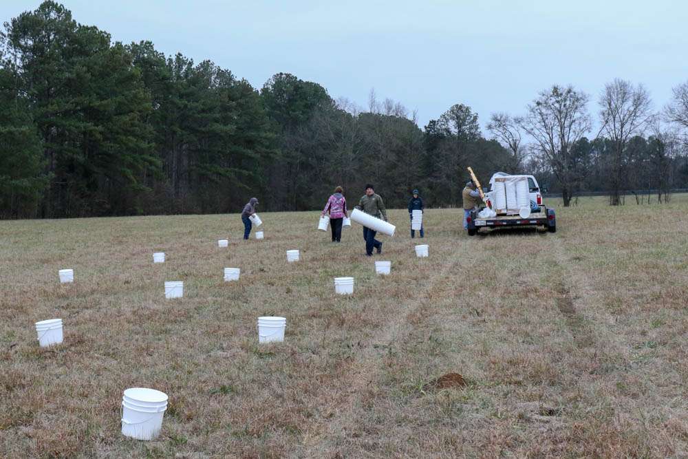 Two gallon buckets were lined up across a large field in Calera, Alabama. 