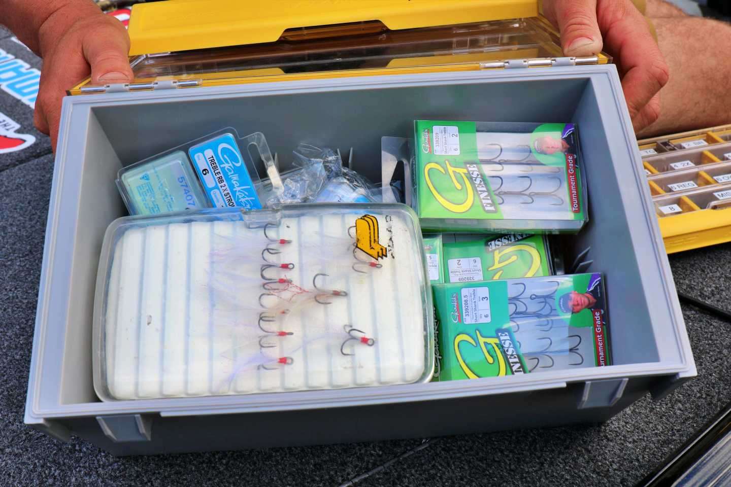 The large box includes removable dividers and has two large side mounted handles. The setup is ideal for soft plastics and molded swimbaits. Gustafson removed the dividers to make room for more hooks. 
