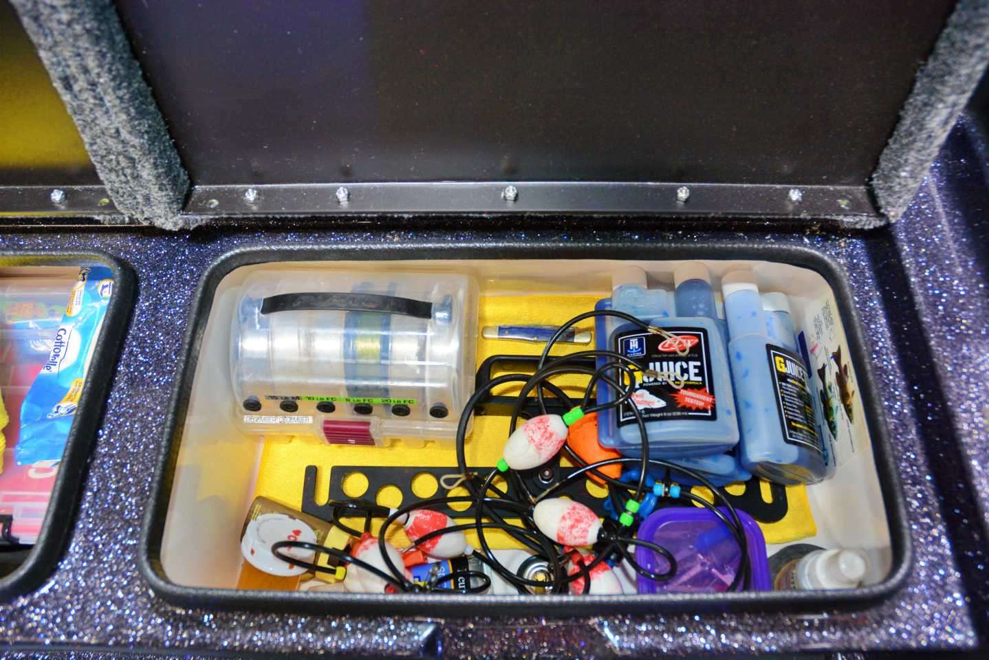 Inside this compartment are items for fish care and culling. A balance beam, cull tags, G-Juice and other related items are stored inside this box that is near the livewell. 
