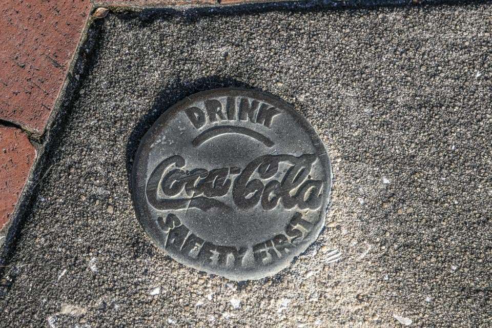 Coca-Cola medallions can be found along the sidewalks of the historic district. They were placed there decades ago when the company operated a bottling plant in the town.