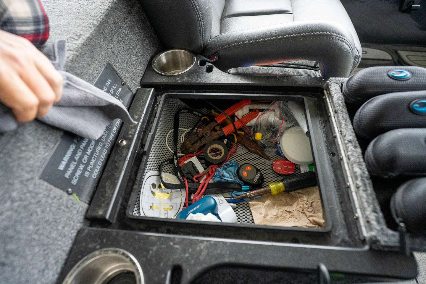 Underneath are more tools and various items he can get to while driving the boat. 