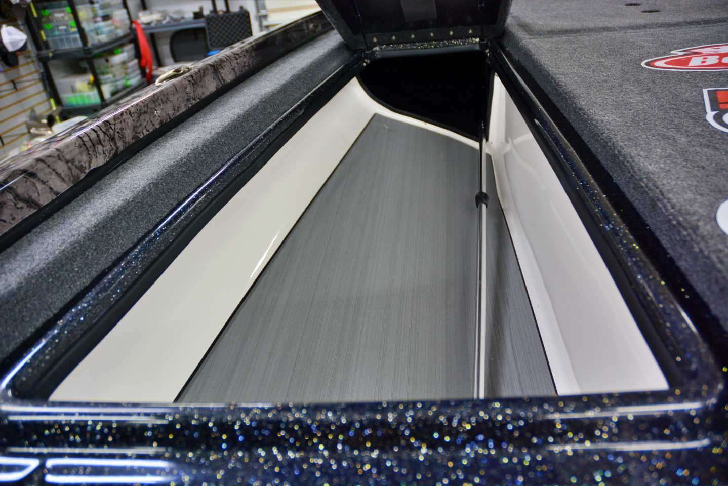 The port rod storage features SeaDek flooring for quick drying of wet combos. Atkins removes the rod organizer in favor of using Rod Gloves. This setup allows him to put all the rods he needs in the compartment.  