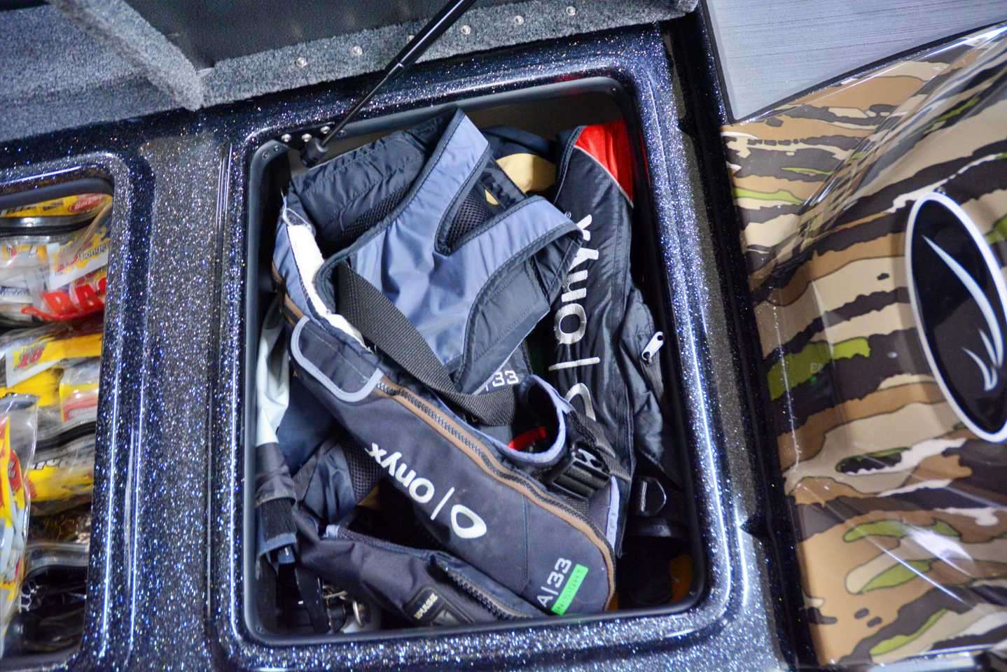 Forward of the console and between the soft plastic box is quick access to PFDs and outerwear like raingear.  