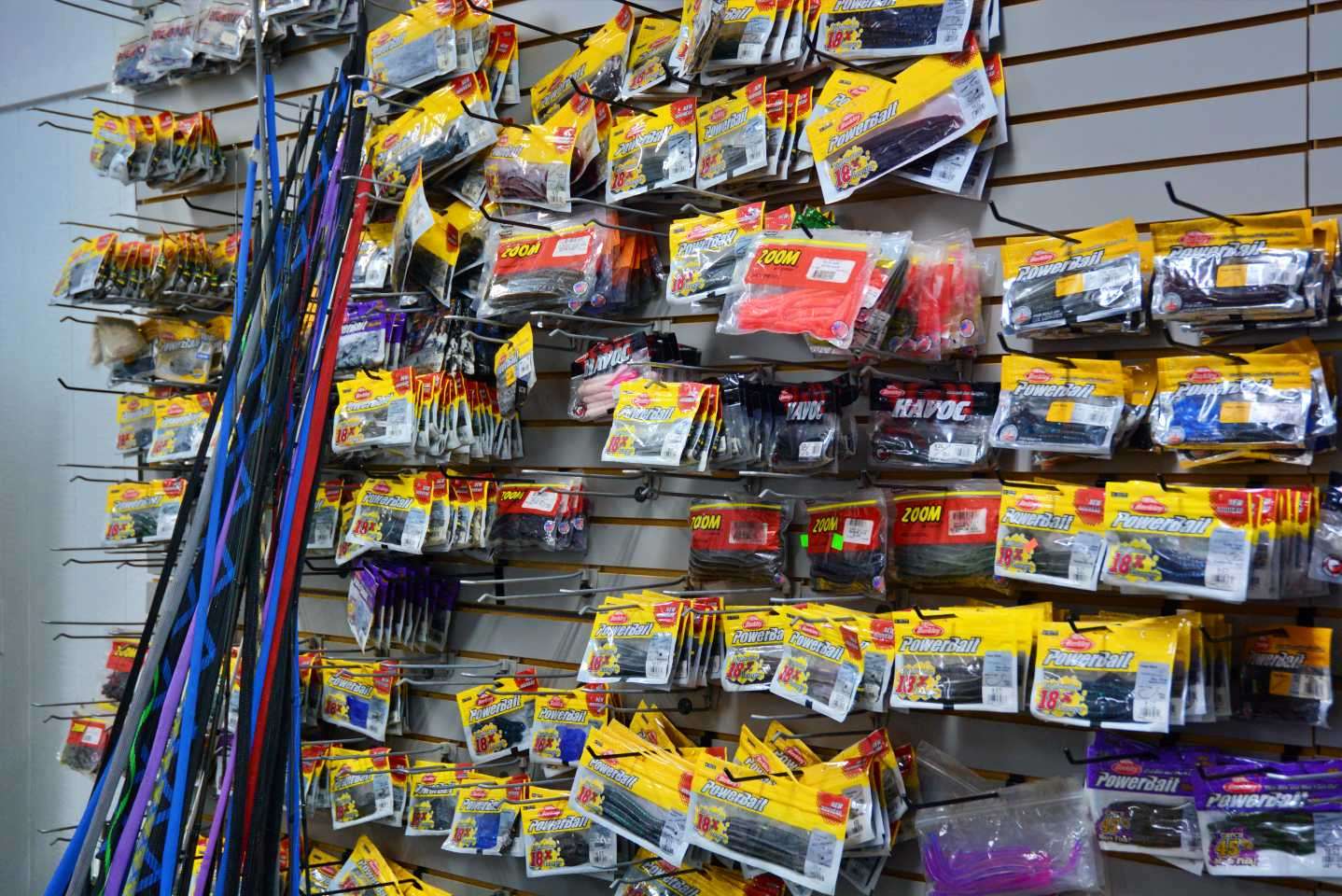 The wall is lined with Berkley PowerBait soft plastics.