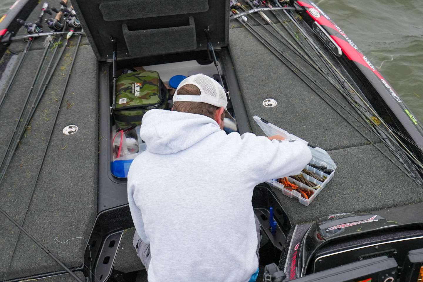 Logan digs around in his Skeeter FXR to get his lure rigged up. 