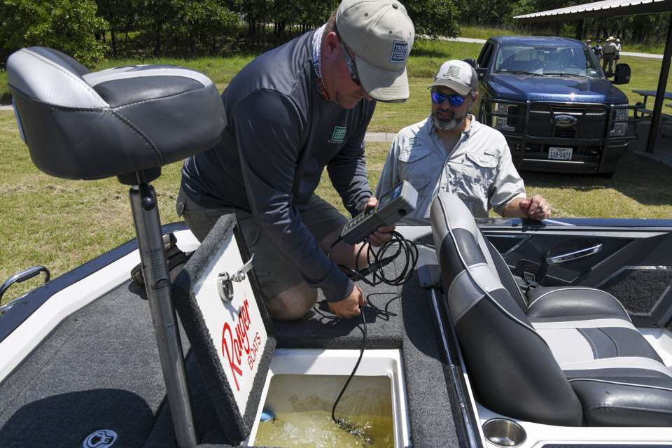 Biologists with the Texas Parks and Wildlife Department prepare the bass for their ride back to Fort Worth. 