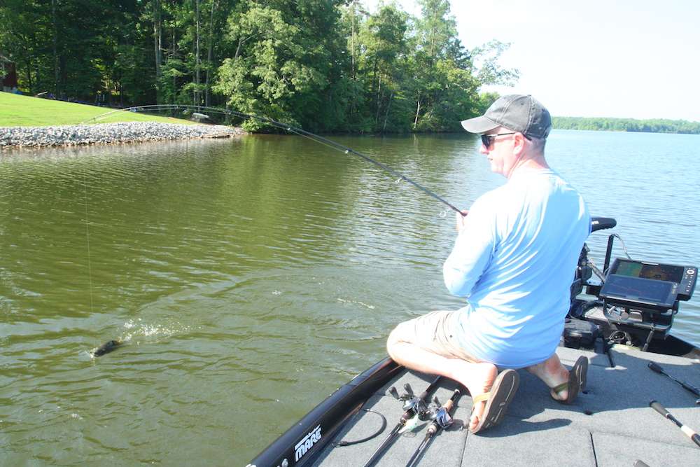 <b>9:14 a.m.</b> Loughran casts the Neko rig to a dock, hops and shakes the tiny worm down the bank slope, and a big fish loads on! He works it carefully to the boat and grabs his third keeper of the day, a 4-pound, 1-ounce largemouth. Its tail is rubbed raw from spawning. âI spotted an empty bass bed up shallow, then this spawner hit out in 5 feet of water; late spawners often make their beds out deeper.â <br>
<b>9:24 a.m.</b> Loughran continues uplake while casting the Neko rig and Plopper to docks. <br>
<b>9:39 a.m.</b> He retrieves the Plopper past a shaded seawall. Nothing there. 
<br><br>
<b>4 HOURS LEFT</B><BR>
<b>9:59 a.m.</b> Loughranâs shallow strategy so far has been to target docks and scattered cover with the Neko rig while probing shaded banks and shallow pockets with the Whopper Plopper. Heâs reached the last cluster of docks and cranks the swimbait with no takers. <br>
<b>10:06 a.m.</b> Loughran pitches the Neko rig to a dock and nails his fourth keeper, 3 pounds, 1 ounce. <br>
<b>10:12 a.m.</b> Loughran skips the Neko rig around the farthest dock uplake. Whatâs his take on the day so far? âHaving caught three postspawn keepers and one spawning fish so far, itâs shaking out pretty much like I expected. Iâll try to finish out my limit up shallow within the next hour, then move out deeper and probe some offshore structure.â <br>
<b>10:18 a.m.</b> Loughran hops the Neko rig around a big laydown. <br>
<b>10:22 a.m.</b> He catches a short fish off the laydown on the Fuse worm. <br>
<b>10:26 a.m.</b> Loughran retrieves a homemade black and blue 3/8-ounce swim jig with a matching Missile Baits Twin Turbo trailer around shallow bluegill beds. <br>
<b>10:47 a.m.</b> Loughran has reached the extreme upper end of the lake. âIâm seeing plenty of stumps and bream beds way up here, but so far, no bass.â
<br><br>
<b>3 HOURS LEFT</B><BR>
<b>10:58 a.m.</b> Loughran idles back to the dock where he caught his 3-1 and tries the swimbait without success. <br>
<b>11:14 a.m.</b> Loughran moves to an offshore rockpile and casts the Fuse worm to a sunken log heâs graphed on the structure. He immediately catches his fifth keeper, 2 pounds, 10 ounces. <br>
<b>11:22 a.m.</b> He catches his sixth keeper, 1 pound even, off the rockpile. <br>
<b>11:30 a.m.</b> Loughran makes a short hop to a long point, where he tries the Fuse worm and crankbait without success.
<br><br>
<b>2 HOURS LEFT</B><BR>
<b>11:58 a.m.</b> Loughran has graphed up what appears to be a sunken rowboat in 17 feet of water off the end of a point. He bumps the Fuse worm around the submerged skiff without a tap. <br>
<b>12:09 p.m.</b> A good fish hits the Fuse worm on the point. Loughran tightens down on the bass; it takes off like a rocket and breaks his line. He then rigs up a fresh Fuse worm/drop-shot setup. âLetâs run back to that hump I fished this morning and see if thereâs any fish on it now that the sunâs high.â <br>
<b>12:19 p.m.</b> Loughran makes a blistering run downlake to the offshore hump. He drops the Fuse worm straight down into a 12-foot brushpile and shakes it. <br>
<b>12:24 p.m.</b> He bangs the 5XD off a deep stump on the hump. âI braced myself for a strike, but it didnât happen!â <br>
<b>12:31 p.m.</b> Loughran hops the Fuse worm past another stump and catches his seventh keeper, 2 pounds, 12 ounces. <br>
<b>12:48 p.m.</b> Loughran catches keeper No. 8, 2 pounds, 8 ounces, off another stump on the high spot. âThis fish was right at the edge of the dropoff. They sure arenât stacked up tight on this hump; itâs just one fish here and another fish there.â Itâs extremely hot and humid, with dark clouds building rapidly out to the west. âThereâs a big storm headed this way. If weâre lucky, weâll wrap this article up right before it hits.â
<br><br>
<b>1 HOUR LEFT</b><br>
<b>1:01 p.m.</b> Loughran grinds the 5XD around the hump. âThey sure arenât wanting a crankbait today!â <br>
<b>1:11 p.m.</b> Now focusing solely on isolated cover on the hump, Loughran shakes the Fuse worm vertically in a 12-foot brushpile.
