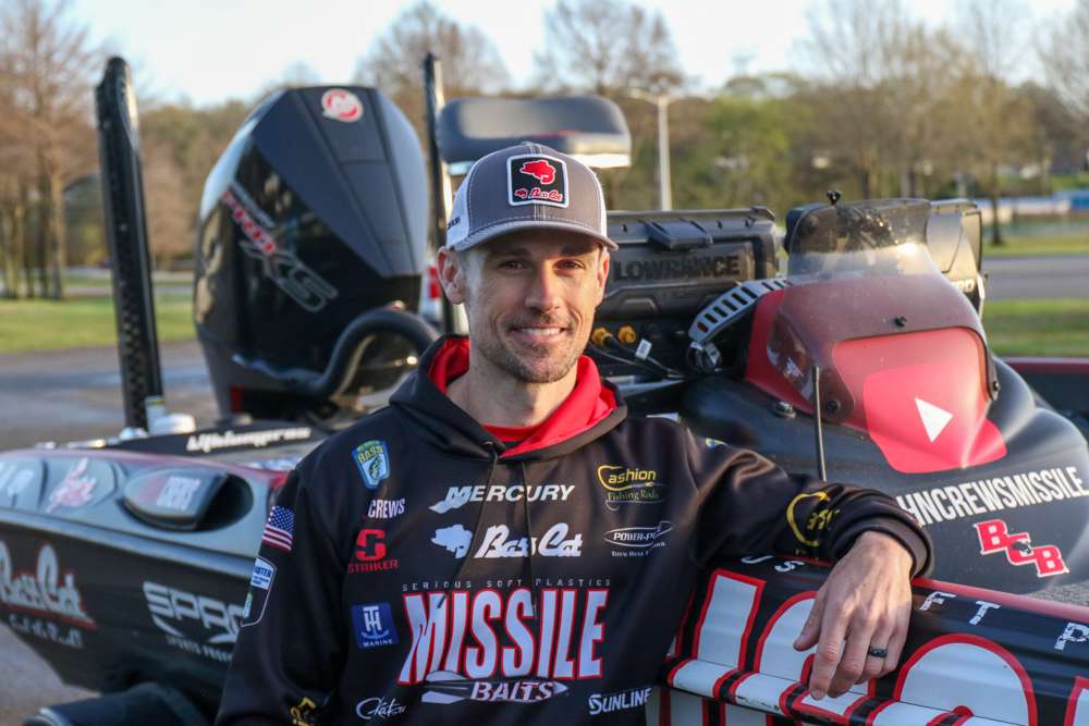 Bassmaster Elite Series veteran John Crews poses with his 2021 Bass Cat Eyra, powered by a 250 horsepower Mercury Pro XS outboard. 