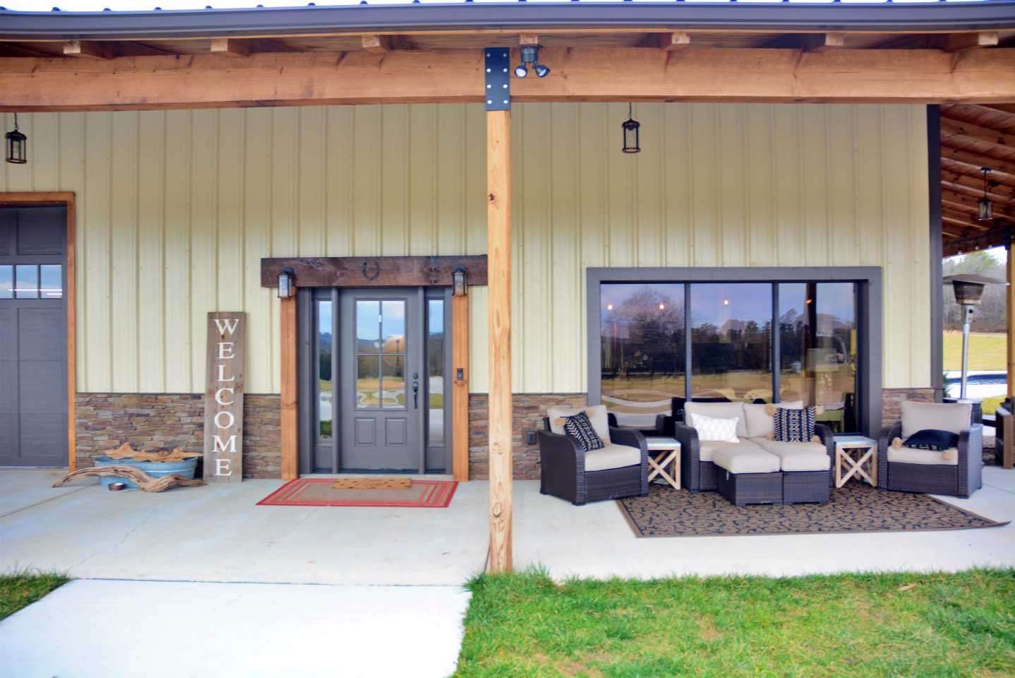 What began as a 40 x 60 metal barn for boat and tackle storage grew to a three-bedroom house, with two full bathrooms, a kitchen and living room. Here is the front door to the living space. 