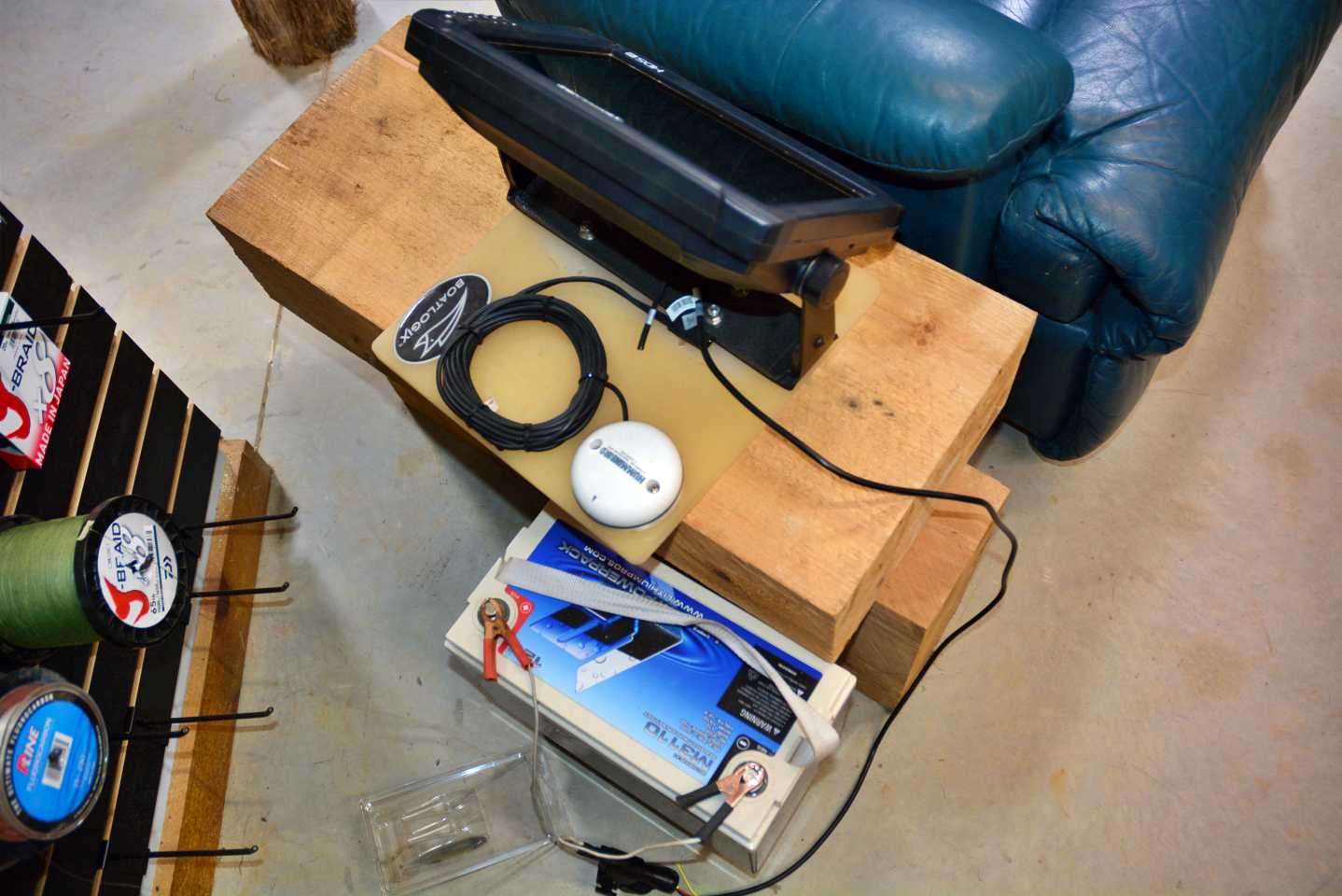 Beside the chair is a Lithium Pros battery and Lowrance unit and receiver. âI work on waypoint management while Iâm watching reruns of Bassmaster LIVE.â Gross unmounts a unit from the boat, brings it here, hooks it up and goes to work.