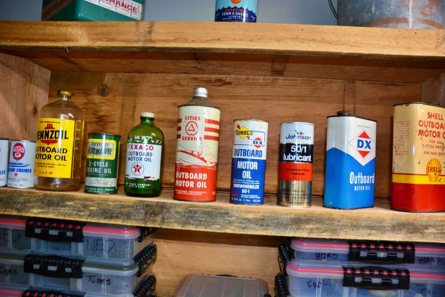Another shelf filled with vintage oil cans. 