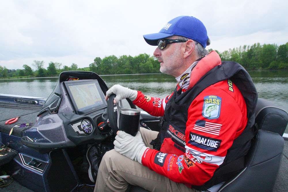 The end of 2018 was a period of significant upheaval in the world of professional bass fishing. Many longtime B.A.S.S. pros abandoned the Elite Series for a new, competing tournament circuit, one with a radically different format that eliminated a staged weigh-in and put a premium on quantity, not quality. One notable holdout was Mark Menendez, a Â­29-year veteran of B.A.S.S. competition. âIâve been with B.A.S.S. since the get-go, and B.A.S.S. is where Iâm staying,â Menendez says. âFishing B.A.S.S. events has allowed me to make a good living and given me the notoriety thatâs led to my successful side gigs as a tackle industry consultant, seminar speaker and TV show host. The 2019 crop of Elite Series anglers, many of whom are young and as yet relatively unknown, are smart, articulate and highly skilled â some of these guys arenât merely good, theyâre scary good. But hey, Iâm holding my own. Weâve had four Elite tournaments so far this year; I may be an old fart, but I placed third in one, sixth in another.â One canât help but find Menendezâs loyalty and optimism refreshing in these tumultuous times. But just how good a bass fisherman is he? Youâre about to find out as Menendez stages a memorable spawn-time whackfest on Lake E.
<br><br>
<b>6:20 a.m.</b> We arrive at Lake Eâs launch ramp. Menendez pulls an arsenal of Lewâs rods and reels from storage; theyâre rigged with an assortment of Strike King lures. âWith this storm front approaching, it could get crazy out here today,â he says. âI wouldnât be surprised to find fish moving in shallow to spawn, on bed and in postspawn mode. Iâll start out with moving baits, then use bed fishing lures if I spot spawners.â
<br><br>
<b>7 HOURS LEFT</B><BR>
<b>6:30 a.m.</b> We launch the Skeeter. Menendez checks the water temp: 68 degrees. âItâs fairly murky, but I should be able to spot shallow beds easily enough.â He puts his boat on plane and embarks on a scouting run uplake.<br>
<b>6:42 a.m.</b> Menendez enters a shallow cove and makes his first casts of the day with a 4.Â­5-inch chartreuse shad Shadalicous swimbait rigged on a 6/0 belly-weighted hook. âThis is an awesome spawn-time search bait. You can cover shallow water quickly with it, and itâs much less obtrusive than a spinnerbait or squarebill crankbait.â <br>
<b>6:47 a.m.</b> Menendez bags his first keeper bass of the day, 1 pound, 4 ounces, on the swimbait. âI saw a light spot on the bottom (a bed), swam the bait over the top and he nailed it.â <br>
<b>6:49 a.m.</b> On his next cast, a small bass rips the Shadalicious off its hook. Menendez rigs a fresh bait and resumes casting to the bank. <br>
<b>6:53 a.m.</b> Menendez lobs the swimbait to a boathouse. A good fish chomps it; he attempts to swing it aboard, but it comes unhooked. âThree-pounder. This could be a real whackfest today!â <br>
<b>7:07 a.m.</b> He slow rolls the Shadalicious past a blowdown tree. A big fish rolls on it but doesnât hook up. <br>
<b>7:11 a.m.</b> Menendez spots a bedding fish on a grassy point, lowers his Power-Poles and flips a black and blue Game Hawg creature with a pegged 5/Â­16-ounce sinker to the nest. <br>
<b>7:14 a.m.</b> Menendez swims the Shadalicious across the nest. The bass bumps it; he swings and misses.
