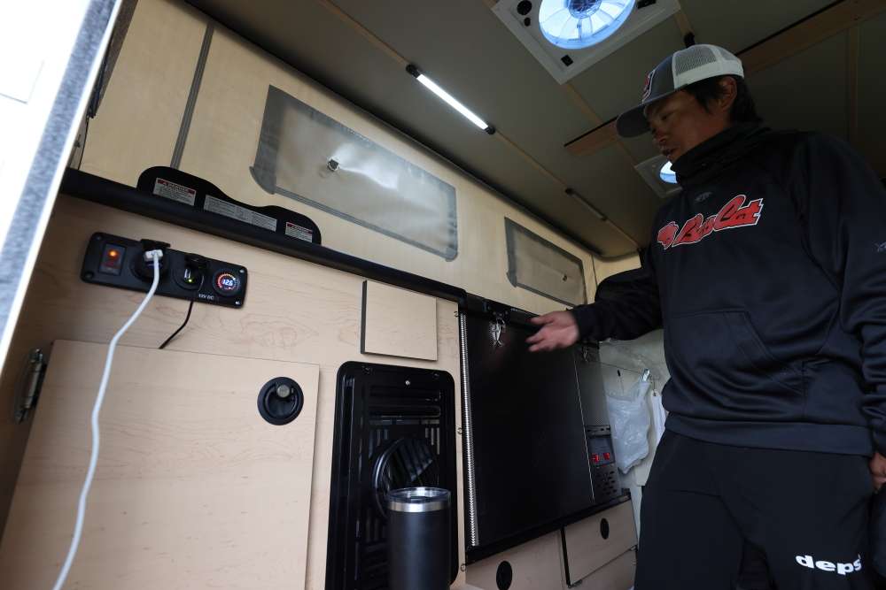 The camper shell has a built-in refrigerator as well as a cooking stove. 