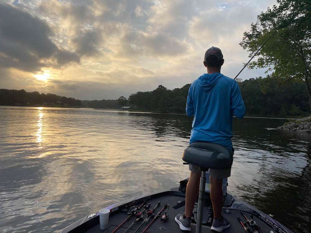 Early September 2020: A vaccine for the coronavirus may still be in developmental stages, but the sport of bass fishing recently received a tremendous shot in the arm thanks to ESPN2âs televised coverage of several recent Elite Series tournaments. Millions of viewers, many of whom had never been exposed to bass fishing before, were glued to their sets watching pro anglers battle bass, the clock, rough water and each other. Mere ounces often separated the top competitors, and the lead changed virtually every time a fish was boated. Among the cadre of young pros who dominated much of the televised action was North Carolinaâs Shane LeHew. âThe TV coverage of our summer Elite tournaments, especially the Northern Swing events, was awesome, but it put a lot more pressure on us anglers to perform,â he recalls. No worries there for the Baby Shark. While he had previously been quoted as favoring shallow water and lacking confidence in fishing offshore, LeHew placed 16th at Lake Champlain (New York) and seventh at Lake St. Clair (Michigan), mostly by targeting structure far from the bank. âIâve learned you have to be proficient in every style of bass fishing if you even hope to compete in the Elites,â LeHew admits. Hop aboard LeHewâs boat as he uses his skills at offshore angling to catch bass in what is traditionally one of the toughest times of year: the summer/fall transition.<br><br>
<b>6:32 a.m.</b> Itâs 78 degrees and cloudy when we arrive at Lake Xâs deserted boat ramp. LeHew preps his rig for launching. âA monster thunderstorm hit last night just as I pulled into my motel,â he says as he wipes down the Rangerâs soggy seats. âI never ever saw so much lightning! September is a transitional month â some bass are usually shallow while others are still on their deep summer pattern. If that lightning didnât spook âem, I should be able to catch some fish up shallow on topwaters. This thick cloud cover is supposed to start clearing out around late morning; then Iâll probably move offshore.â 

