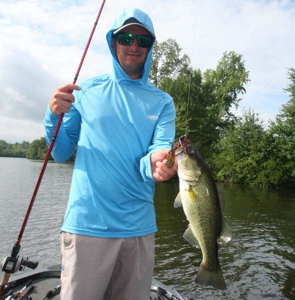 <b>4 HOURS LEFT</b><br>
<b>9:52 a.m.</b> LeHew again pitches the jig to the laydown. His line hops, and he sets the hook and swings aboard a 2-pound, 7-ounce largemouth, his first keeper of the day. âThis fish hit right at the end of the branches that stretch out over deep water. He bit just as I was working the jig around a limb.â <br>
<b>10:02 a.m.</b> LeHew switches Power Worm colors to cherry and casts the crawler around the channel bank. <br>
<b>10:07 a.m.</b> LeHew moves to a nearby bank littered with fallen trees. He runs the shoreline while making short pitches with the jig and buzzbait. âYouâd think thereâd be some bass around all this wood cover, but youâd be wrong!â <br>
<b>10:14 a.m.</b> LeHew zips to the opposite shoreline, where he tries the jig and Choppo around a moored pontoon boat. <br>
<b>10:30 a.m.</b> The sun pops out and it instantly turns stifling hot. LeHew cranks the Dredger 8.5 around another boathouse. Whatâs his take on the day so far? âWeâre in a transitional period to begin with, but I fear my concern about the lightning spooking the fish has proven accurate. Iâve seen this happen before after a severe thunderstorm; theyâll get lockjaw and hunker down until conditions improve. The thick cloud cover is breaking up, however, so hopefully thatâll get âem going a little more. Iâve marked several brushpiles and Iâll hit some more docks, especially docks with cover around them.â <br>
<b>10:46 a.m.</b> LeHew moves to the mouth of a shallow cove and cranks the Dredger 14.5 around a boat ramp.
<br><br>
<b>3 HOURS LEFT</b><br>
<b>10:50 a.m.</b> Rather than retrieving the crankbait nonstop, LeHew is reeling it down to the bottom, then moving it slowly with short pulls of the rod interspersed with slow turns of the reel handle. âTheyâre really inactive, so Iâm literally feeling the plug along the bottom, then pausing once it contacts cover.â A fish taps the lure but doesnât hook up. <br>
<b>11:01 a.m.</b> LeHew pauses to rig a black Bottom Hopper 6.25 finesse worm on a 1/8-ounce shaky head jig (both by Berkley). âThis is a deadly combination for probing scattered brush, laydowns, stumps and rocks.â 
