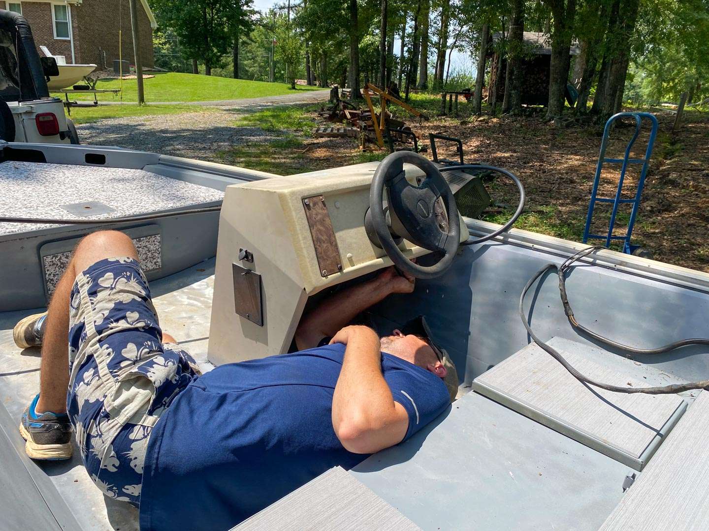 Time to remove the engine. This was a little beyond my skill set, so I asked my friend Paul Moody to do the honors. Because the outboard had great compression, we wanted to keep the steering and controls intact to use it on a future project. 