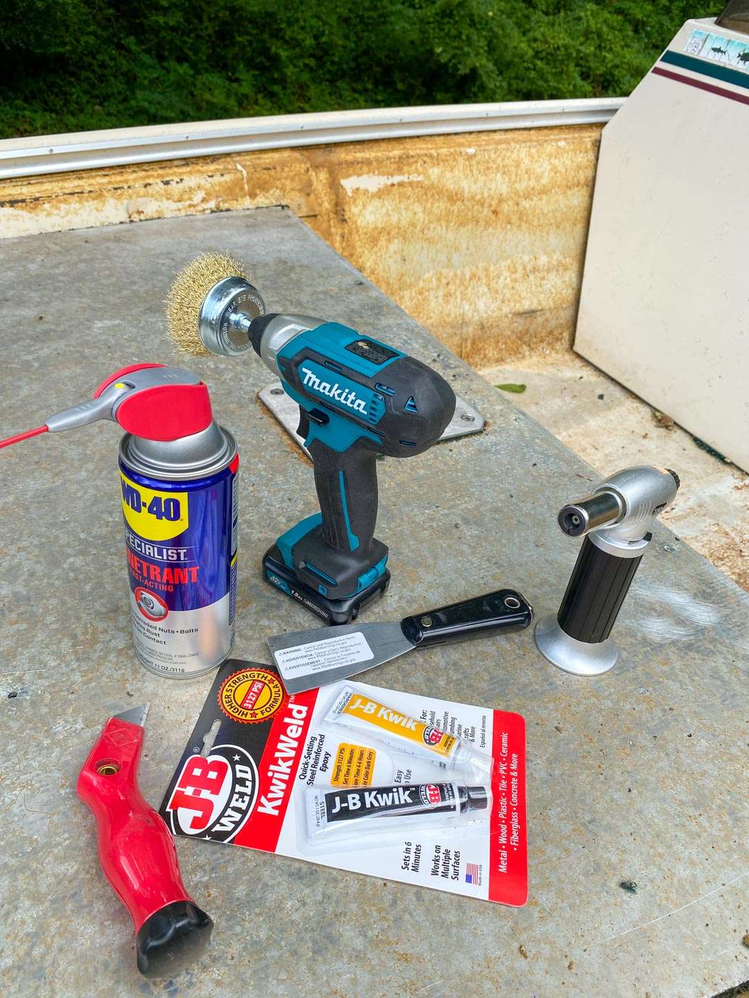 Here are a few items I grabbed from Home Depot. The wire brush for the drill proved invaluable. I used the JB weld to fill a small crack in the floor. The putty knife was used for scraping off glue and the torch was to burn off edges of carpet that I could not remove any other way. The WD 40 helped me loosen screws to eventually remove the seats.