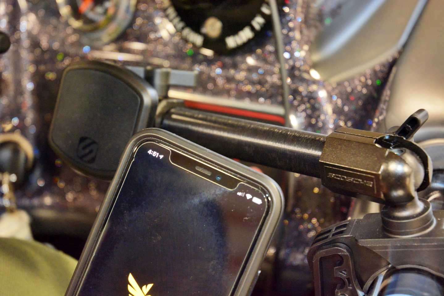 The Scosche MagicMount clamps on the rail near the helm to secure Carlâs smartphone. 